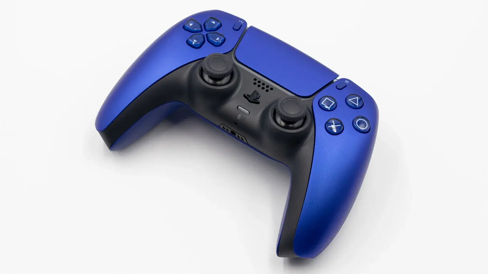 A cobalt blue PlayStation 5 DualSense controller on a plain white surface.